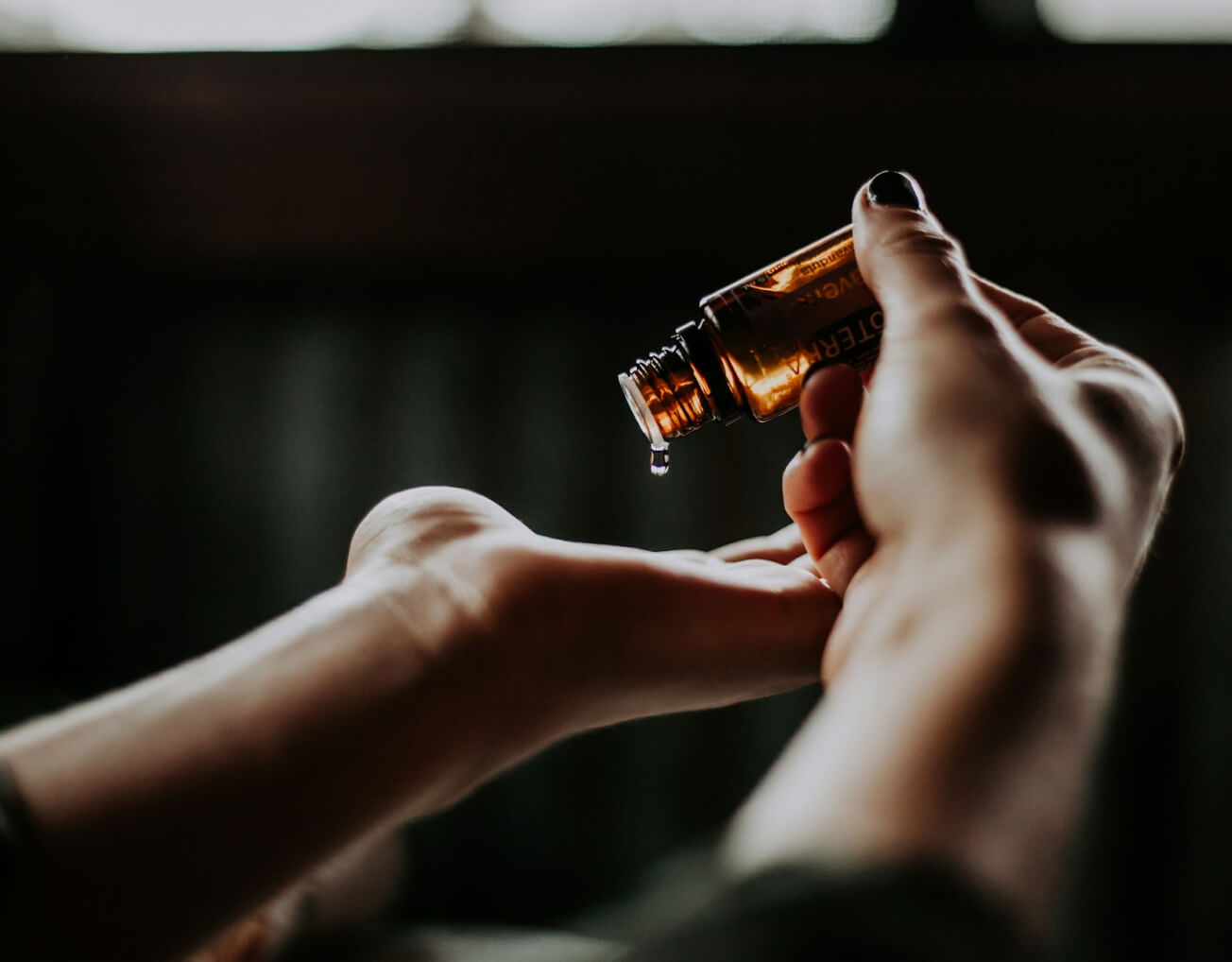 massage oil being poured into a woman's hands at Barnsgrove, Hampshire